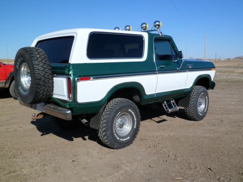 1979 Ford Bronco - This 1979 Ford Bronco features a two-tone green and white paint scheme and a rear-mounted spare tire.