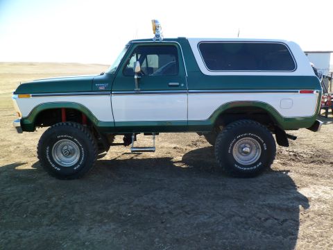1979 Ford Bronco - Side view of a lifted 1978 Ford Bronco with two-tone paint and off-road tires.