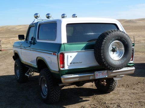 1979 Ford Bronco - This two-tone Ford Bronco is shown from the rear, with a spare tire mounted on the tailgate.