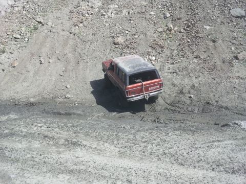 1978 Ford Bronco - This 1978 Ford Bronco navigates a steep, muddy incline, its off-road capabilities.