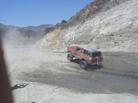 1978 Ford Bronco - 1978 Ford Bronco kicks up dust while navigating a rough off-road trail.