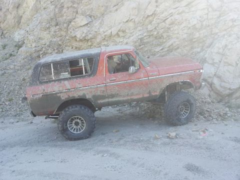 1978 Ford Bronco - This 1978 Ford Bronco navigates a , off-road path with large tires and a lifted suspension.