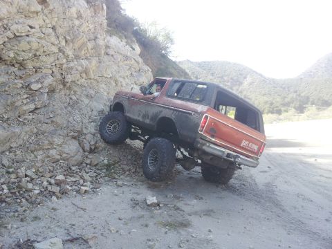 1978 Ford Bronco - This modified 1978 Ford Bronco is navigating a steep, rocky path in a mountainous area.