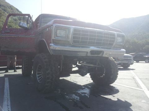 1978 Ford Bronco - This heavily modified truck features a 6x6 drivetrain and aggressive off-road tires, with its grille suggesting a 1978 model year.