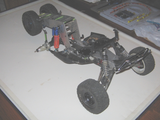 Remote control car chassis with exposed suspension and drivetrain components