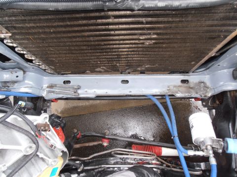1990 Ford Bronco - Close-up view of the engine bay, focusing on the radiator and associated plumbing.