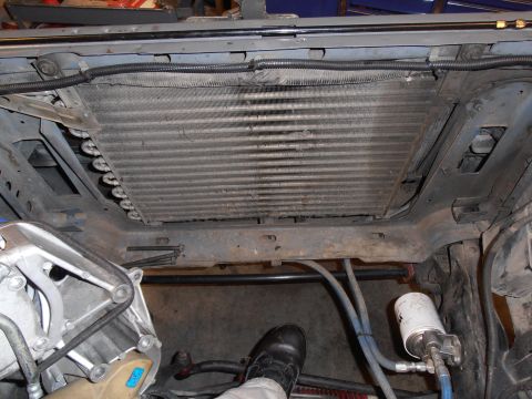 1990 Ford Bronco - The front end of a vehicle is disassembled, revealing the radiator and associated engine components.