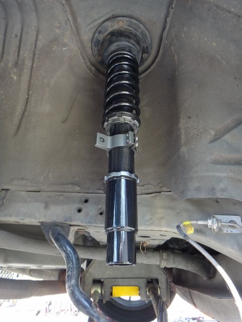 1995 Ford Taurus - Close-up of an aftermarket coilover suspension part, likely for performance tuning.
