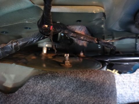 1995 Ford Taurus - Close-up view of suspension mounting hardware, showing bolts and wiring harness.
