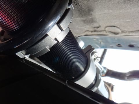 1995 Ford Taurus - Close-up view of a black coilover suspension component with silver adjustable collars, likely an aftermarket part.