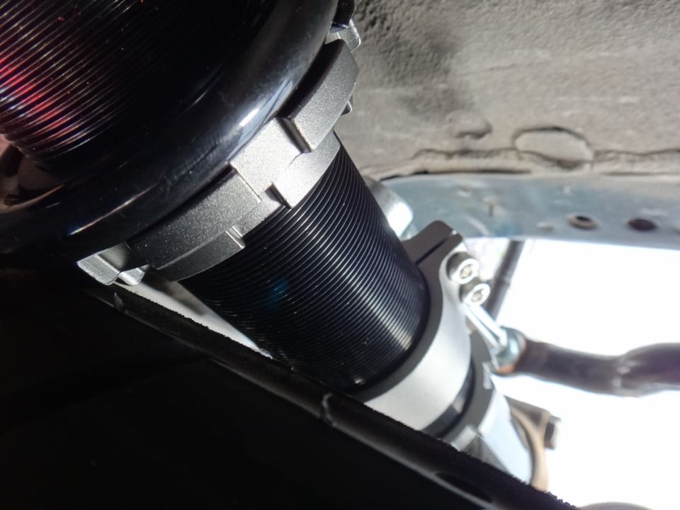 Black coilover suspension with silver adjustable collars