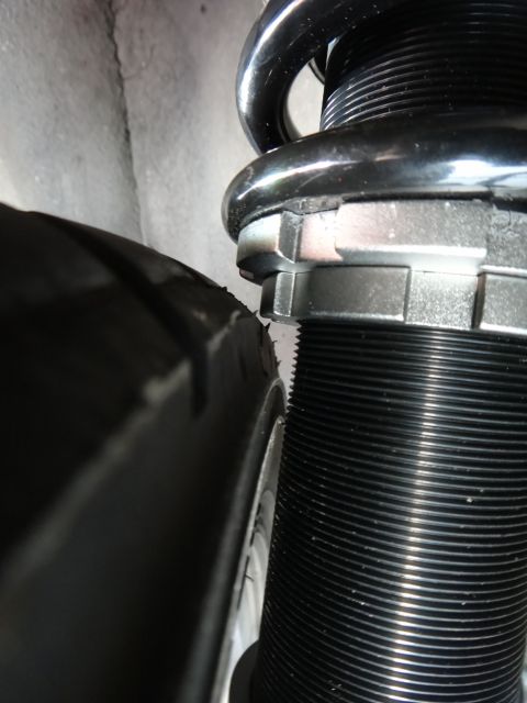 1995 Ford Taurus - A close-up view shows a tire and part of a coilover suspension system.