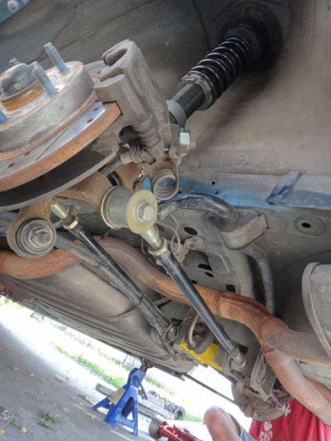1995 Ford Taurus - Close-up view of the rear suspension system, coilovers and brake components on a 1995 Ford Taurus.