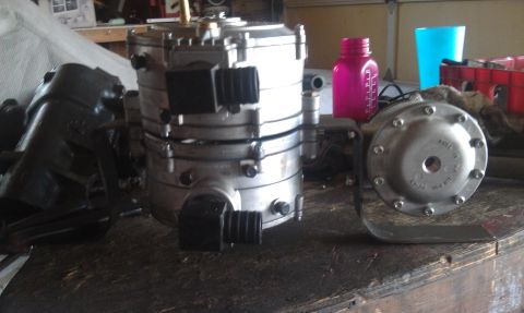 1978 Ford Bronco - Propane converter and associated parts shown on a workbench, with household items in the background.