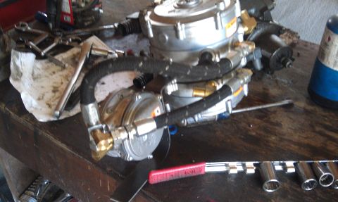 1978 Ford Bronco - Propane regulator assembly and tools laid out on a workbench.