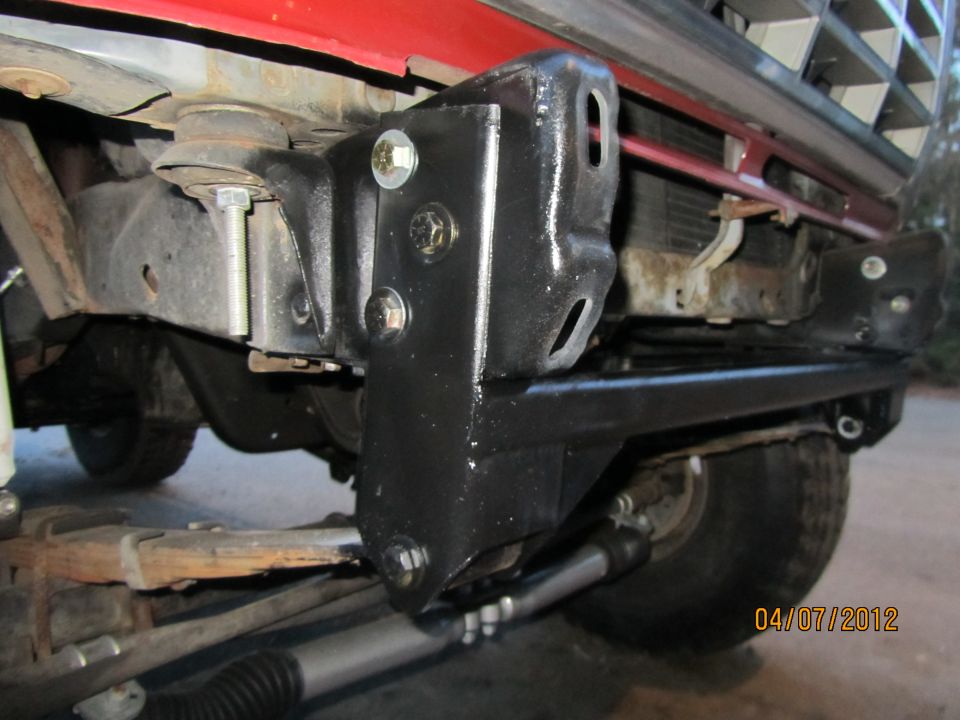 Red Ford Bronco front bumper mount with black paint and visible bolts