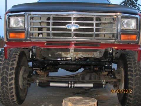 1984 Ford Bronco - Front view of a red Ford truck, its chrome grille and visible suspension components. The date 04/07/2012 is visible.