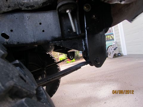 1984 Ford Bronco - The photo shows the undercarriage of a vehicle, focusing on the suspension system and frame components.
