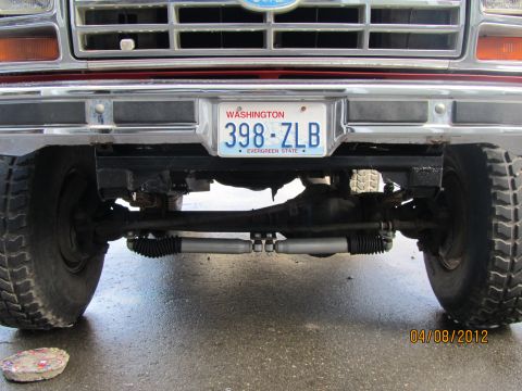 1984 Ford Bronco - Close-up of the front suspension and steering components of a Ford truck.