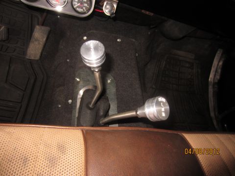 1979 Ford Bronco - Interior view of a vehicle's floor console showing two gear shifters and floor mats.