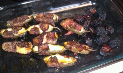 1989 Ford Bronco - Bacon-wrapped jalapenos with cheese filling, some pieces are burnt, in a glass baking dish.