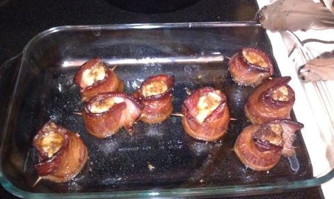 1989 Ford Bronco - Several food items wrapped in bacon are arranged in a glass baking dish, ready to be cooked.