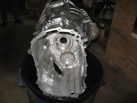 1994 Ford Bronco - A disassembled transmission casing is shown, revealing its internal mechanical components.