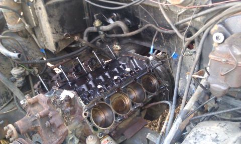 1986 Ford Bronco - The engine block and pistons are exposed, indicating mechanical work is underway.