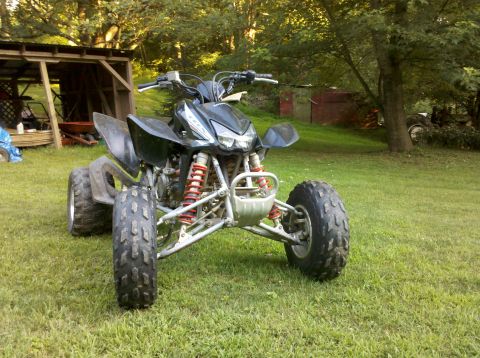 2005 Honda TRX 450 R - Front view of a black 2005 Honda TRX 450 R ATV sitting on a grassy lawn.