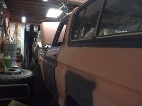 1978 Ford Bronco - Interior view of an orange vehicle, showing the side panel and window.