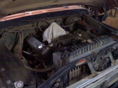 1978 Ford Bronco - A close-up view of a vehicle's engine bay, showing various mechanical parts.