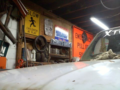 1978 Ford Bronco - The interior of a garage is visible, with graffiti art adorning the walls and bright overhead lights.