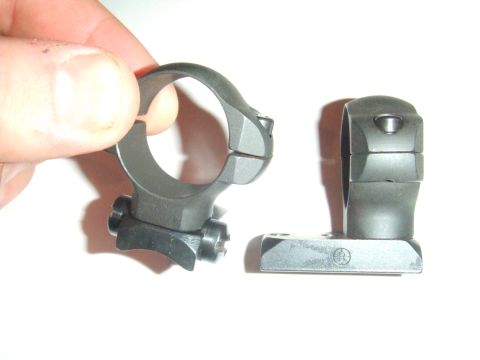 1996 Ford Bronco - Two separate metal components are shown against a white background, with one part being held by a person's hand.