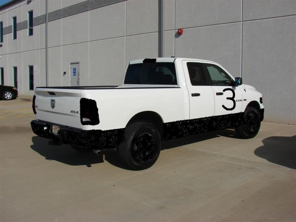 White pickup truck with black lower body and wheels, large number 3 on the door