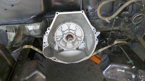 1978 Ford Bronco - The transmission bell housing is visible, detached from the vehicle's main body, suggesting a motor rebuild or repair.