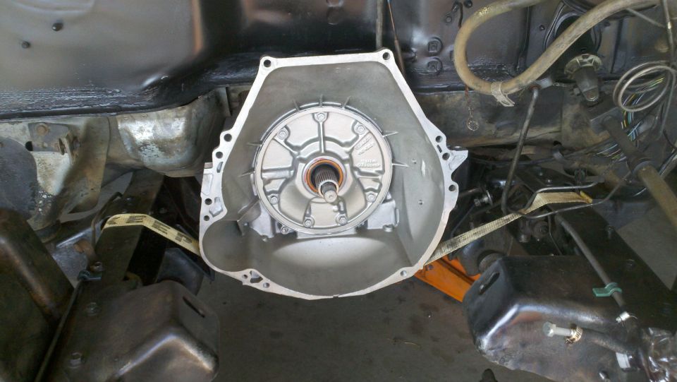 Transmission bell housing removed from vehicle chassis