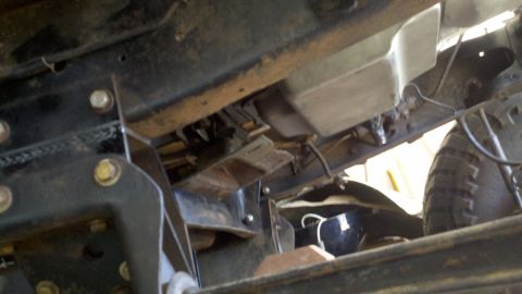 1978 Ford Bronco - A close-up view of the undercarriage reveals the vehicle's frame and suspension system components.