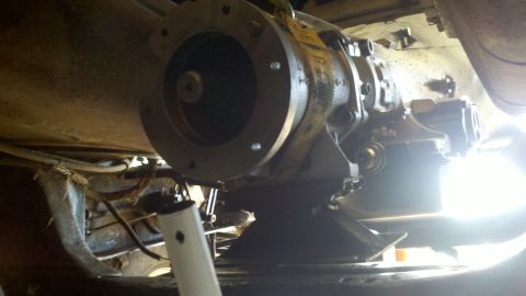1978 Ford Bronco - Underside view of a vehicle transmission component during a motor rebuild.