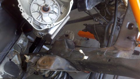 1978 Ford Bronco - Close-up view of transmission and chassis components, likely during a motor rebuild or repair process.