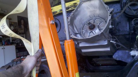 1978 Ford Bronco - Engine and transmission assembly being hoisted out of a vehicle, likely for a rebuild or replacement.