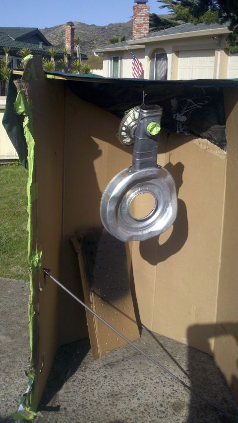 1978 Ford Bronco - Turbocharger suspended for painting inside a makeshift spray booth.