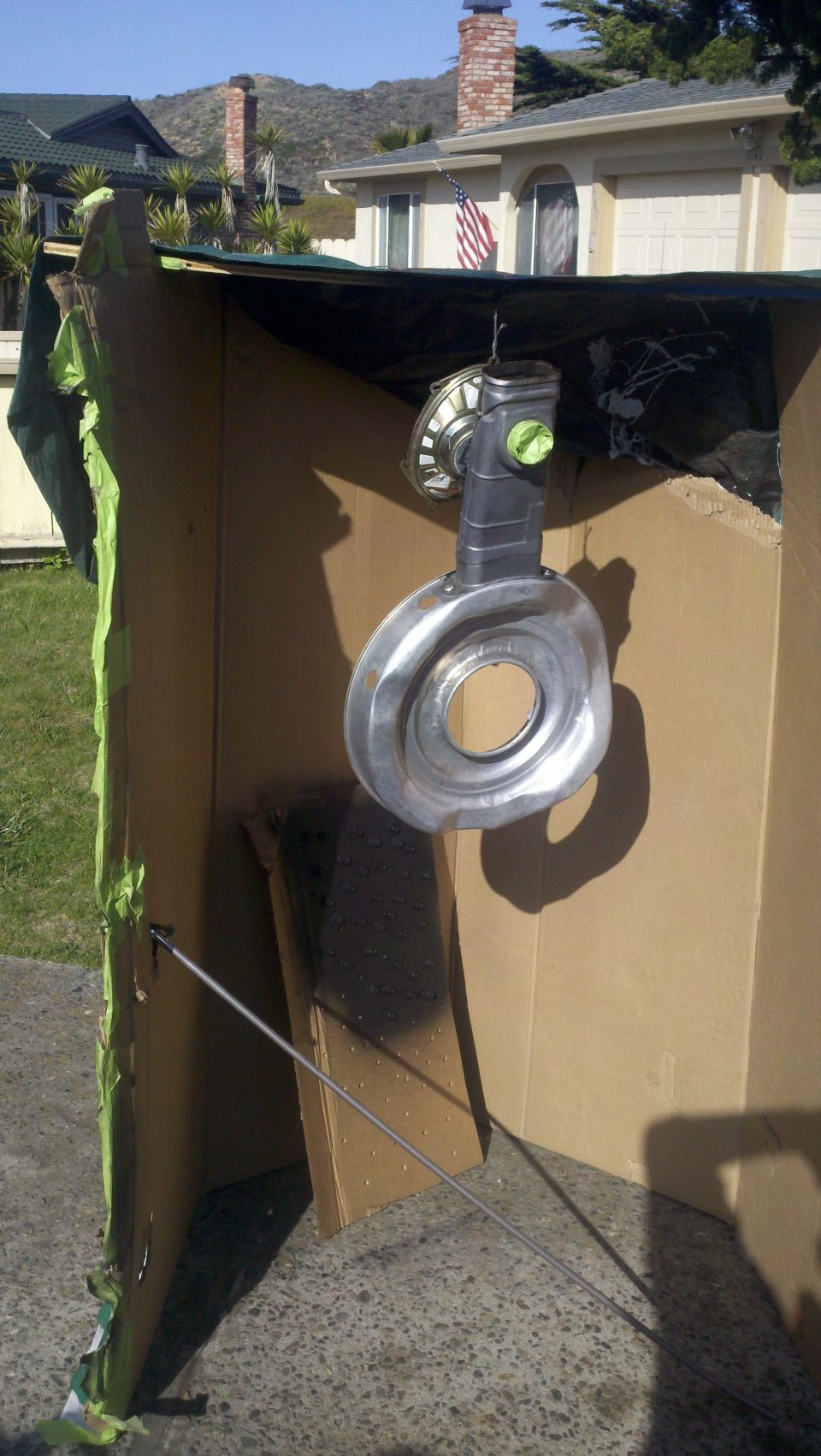 Turbocharger hanging inside a cardboard spray booth