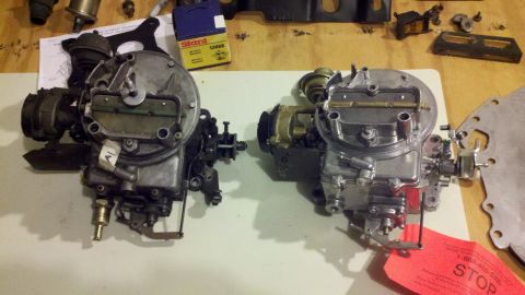 1978 Ford Bronco - Two carburetors are laid out on a table, possibly for a motor rebuild.