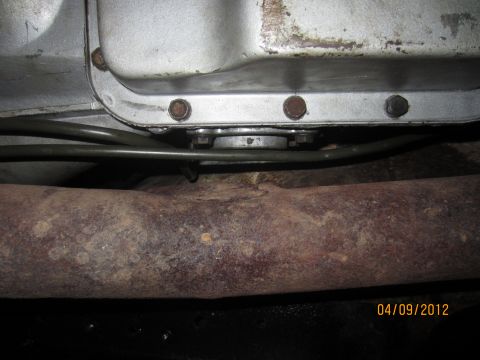 1979 Ford Bronco - Underside view of vehicle components, including transmission pan and exhaust pipe.