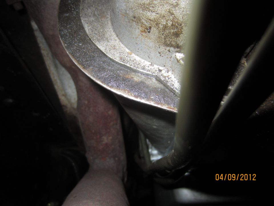 Close-up of exhaust pipe and transmission housing underside