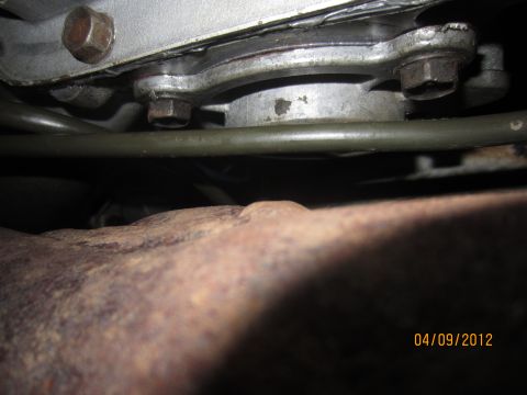 1979 Ford Bronco - A close-up view of vehicle transmission components and a rusty exhaust pipe, with a date stamp of 04/09/2012.