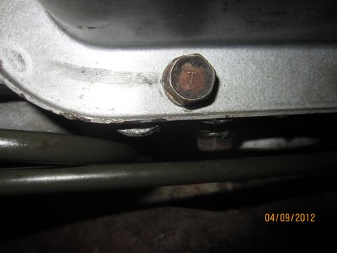 1979 Ford Bronco - A close-up view of a bolt on a vehicle's transmission casing, with a date stamp indicating it was taken in 2012.