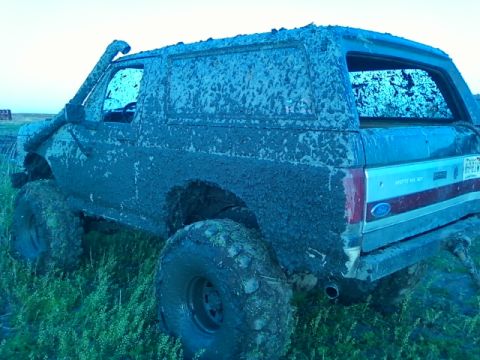 1990 Ford Bronco - This heavily muddied 1987 Ford Bronco is equipped with a snorkel and off-road tires, suggesting it has been used for off-roading.