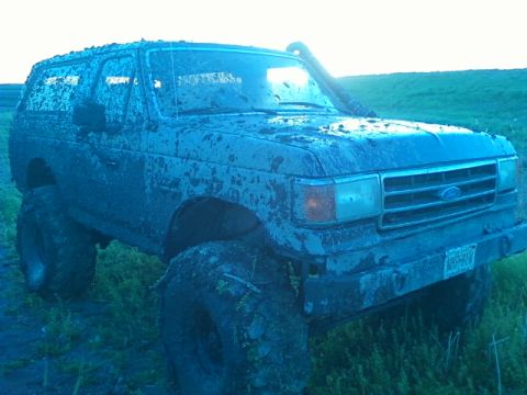 1990 Ford Bronco - This heavily modified 1990 Ford Bronco is caked in mud, oversized tires and a snorkel for off-road adventures.
