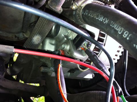 1992 Ford F-150 - Close-up view of alternator wiring, showing connections and surrounding engine components.